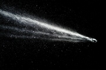 Comet's tail streaking across a dark starry sky