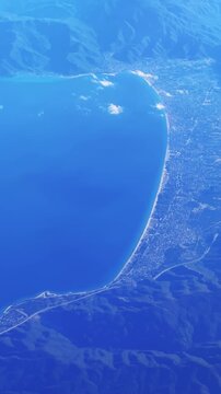 Aerial view of a coastline beach in Greece at Asprovalta with blue sea and distant mountains, vertical video