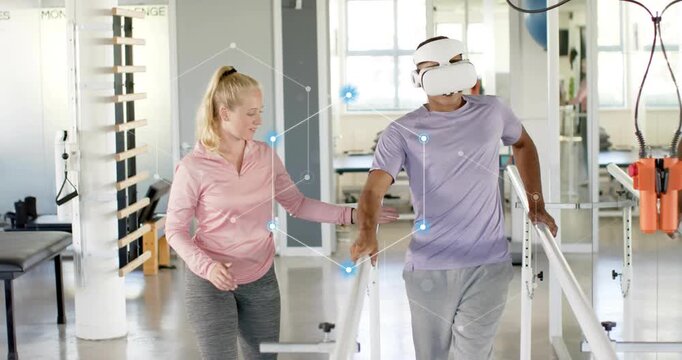 Therapist placing hand for therapy patient wearing VR headset walking parallel bars motion markers