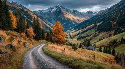 Naklejka premium Winding road through a valley with mountains trees and autumn colors.