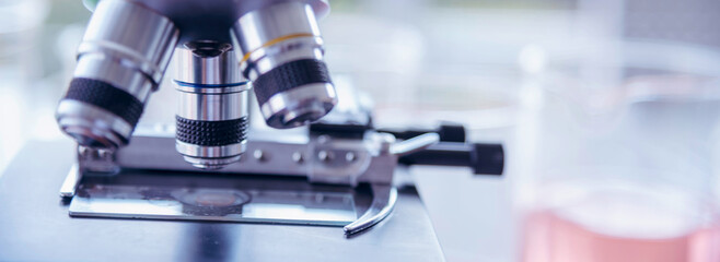 Banner Science laboratory chemistry test science lab with microscope glass tubes chemical beaker scientific background. Colorful Liquid biology laboratory fluid scientist experiment with copy space