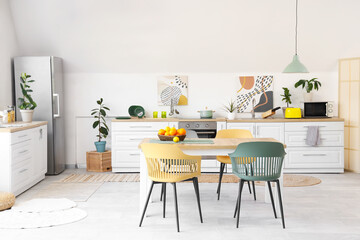 Interior of white kitchen with citruses on table