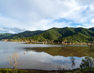 Calm lake reflecting hills
