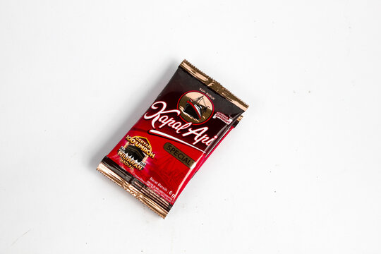 Indonesia, Sukoharjo - June 19, 2025 : black coffee sachets brand steamer (Kapal Api) product from Indonesia, isolated on white background