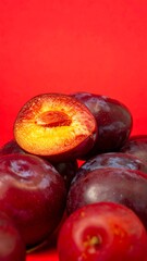 Plums, cut in half, piled up