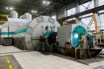 Powerful industrial steam turbine generator set located in thermal power plant machine hall