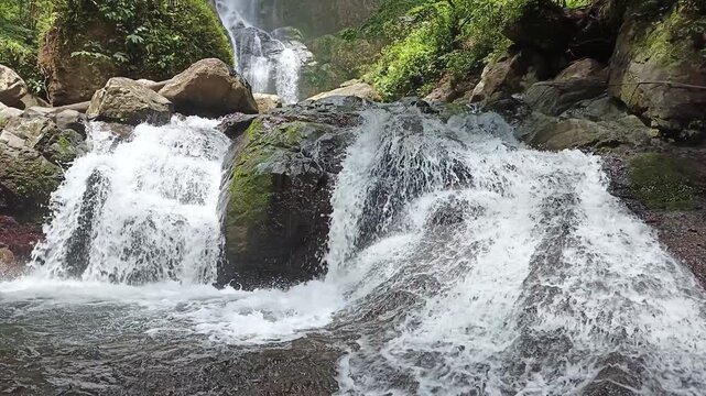 The most beautiful waterfall in Padang City, West Sumatra, Indonesia, with a three-tiered flowing river, is called the Lubuk Hitam waterfall in West Sumatra.