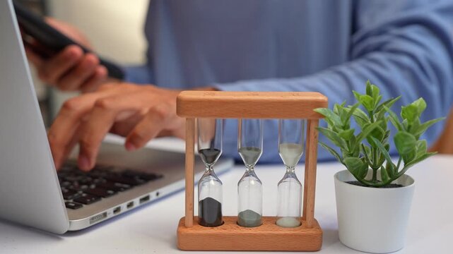 A freelancer juggles multiple devices while racing against hourglasses, symbolizing time management, productivity, stress, adaptability, and the challenge of meeting deadlines in a fast-paced world.
