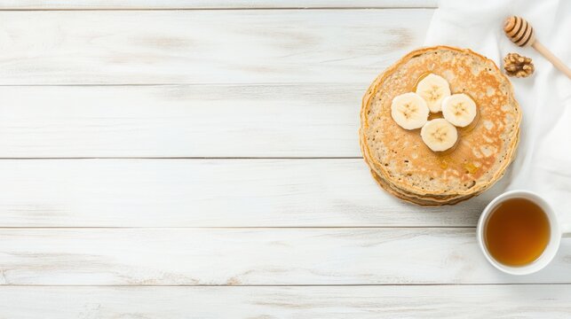 Delicious breakfast pancakes with bananas and honey