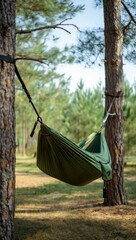Cozy green hammock strung between pine trees in a sun-dappled forest, ideal for outdoor recreation, camping gear, or serene nature scenes