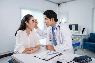 Fototapeta premium Doctor examining patient's face in medical clinic