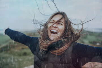 Joyful woman in nature rain
