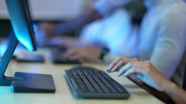 A software developer's hands type rapidly on a keyboard, writing source code in an IDE. This illustrates the fast-paced nature of data input in a tech environment.