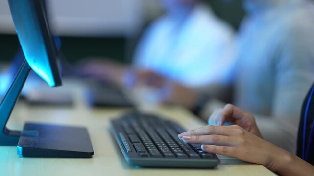 A software developer's hands type rapidly on a keyboard, writing source code in an IDE. This illustrates the fast-paced nature of data input in a tech environment.