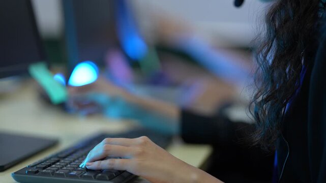 A software developer's hands type rapidly on a keyboard, writing source code in an IDE. This illustrates the fast-paced nature of data input in a tech environment.