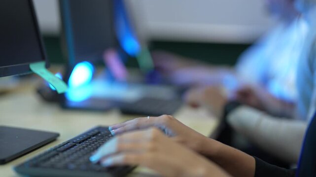 A software developer's hands type rapidly on a keyboard, writing source code in an IDE. This illustrates the fast-paced nature of data input in a tech environment.