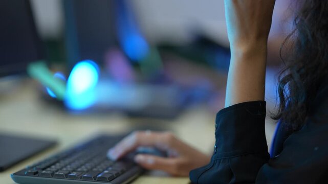 A software developer's hands type rapidly on a keyboard, writing source code in an IDE. This illustrates the fast-paced nature of data input in a tech environment.