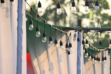 vintage light bulb hang on equipment of party in the evening