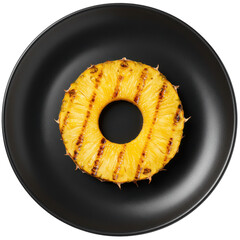 Grilled pineapple ring on matte black plate top down view isolated on white background