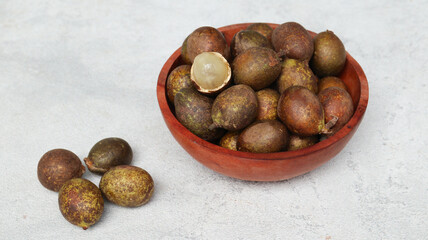 Matoa (Pometia pinnata) on wooden bowl