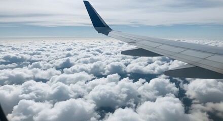 Wing of an airplane over a sea of clouds