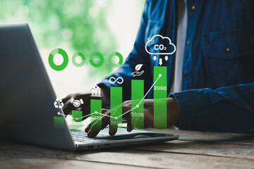 ESG concept, Businessman using digital interface on laptop with environmental, social, and governance icons, sustainability strategy, corporate responsibility, carbon footprint, green business