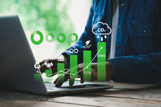 ESG concept, Businessman using digital interface on laptop with environmental, social, and governance icons, sustainability strategy, corporate responsibility, carbon footprint, green business