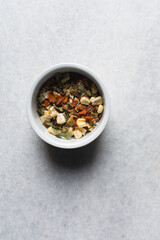 Overhead view of dehydrated mixed vegetables in a white ramekin, top view of mixed dried vegetables on a white countertop