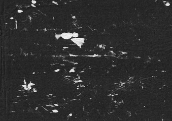 Grunge ink splatter texture on wrinkled paper background. Black and white abstract graphic element. Weathered and old surface template for overlay.