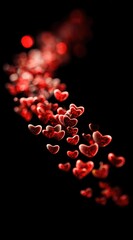 Stream of blurry, red, heart-shaped forms cascade down a dark background, resembling festive confetti in soft focus, creating depth and a sense of movement
