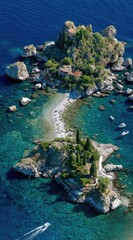 Aerial shot of a small, rocky island covered in vegetation and buildings, surrounded by turquoise water. A thin beach connects its halves