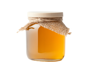 A jar of golden honey with a rustic burlap wrap, isolated on a white background for a fresh and natural look.