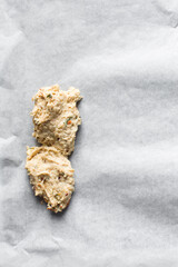 overhead view of savory biscotti dough on a parchment lined baking sheet, top view of savory cookie dough on parchment paper
