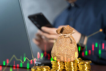 Money bag with gold coins and candlestick chart, financial investment trading and wealth growth...