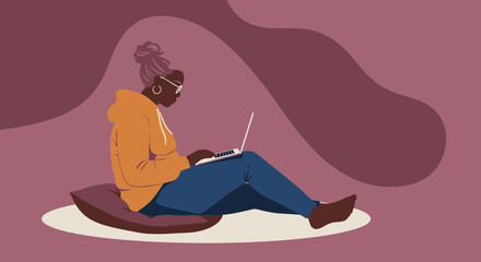 Senior Black woman, casually dressed, diligently working on her laptop from a comfortable floor setup. Ideal for themes of remote work, lifelong learning, or modern digital lifestyle.