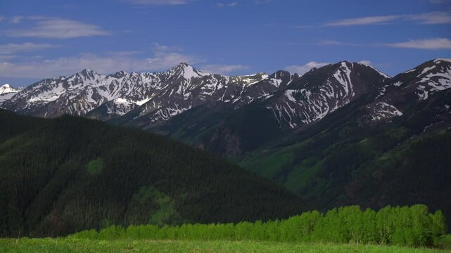 Aspen Mountain Ajax Little Annie Trailhead aerial drone Colorado Conundrum Castle Peak 14er Rocky Mountains Elk Range Aspen Trees spring summer morning blue sky clouds nature landscape pan left motion