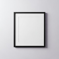Minimal black picture frame mockup on white wall with soft shadow for interior.
