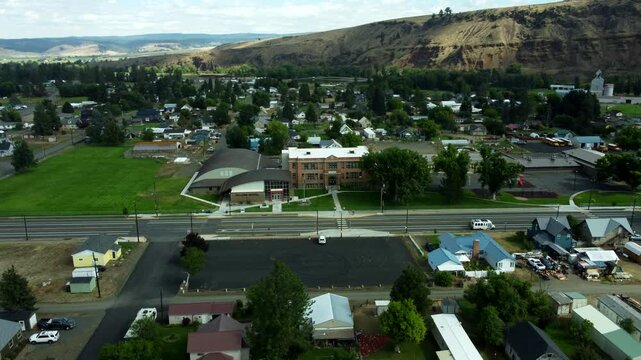 US, Oregon, Wallowa, 2025-08-18 - Drone view of the city of Wallowa, a small farming town in northeast oregon. Orbiting the city school.