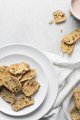 Overhead view of toasted bread chips on white background, top view of crostini bread on marble countertop