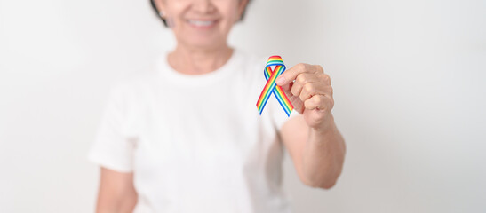 Elderly with LGBTQ Rainbow ribbon for concept of June Pride month, April Autism Awareness, All...