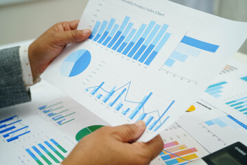 Asian business woman working with financial graph.