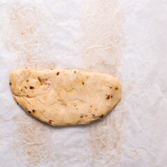 Overhead view of fire crackers dough on parchment paper, top view of spicy cracker dough, process of making fire crackers