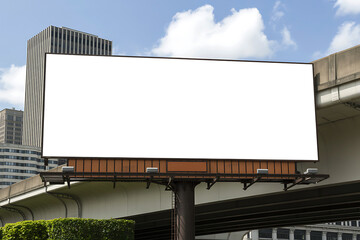 Blank outdoor billboard advertisement space on a sunny day with city buildings in the background