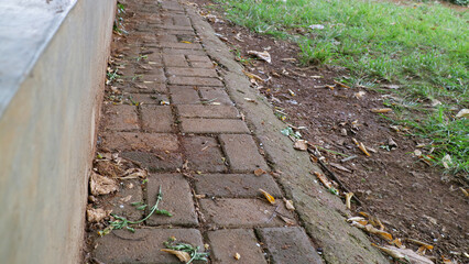 Brick pathway beside grassy area