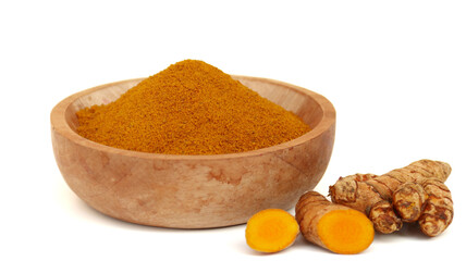 Turmeric powder or Kunyit bubuk, served in wooden bowl, copy space.	
