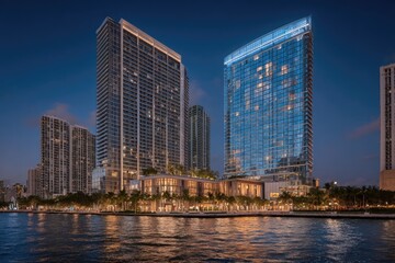 Obraz premium Modern city skyline at twilight, waterfront buildings