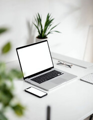 Fototapeta premium Laptop and smartphone mockup on a clean desk with a plant