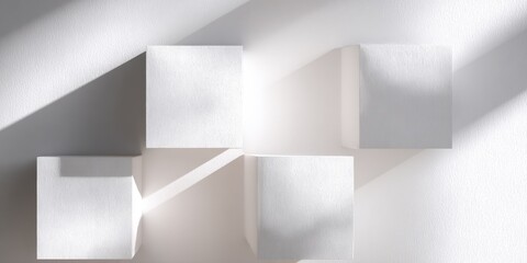 Abstract arrangement of four white cubes, sunlit