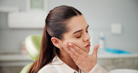 Woman, toothache and stress at dentist with pain, cavity or rotten tooth at oral care clinic. Person, patient and gum disease with inflammation, infection or frustrated at dental health hospital