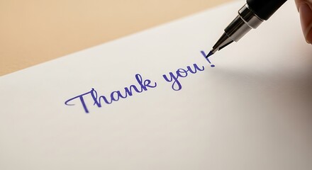 Pen Writes Thank You in Elegant Script on Crisp White Paper Capturing a Moment of Sincere Gratitude and Personal Touch